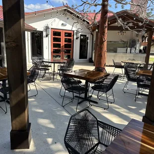 a patio with tables and chairs
