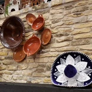 a stone wall with decorative plates on it
