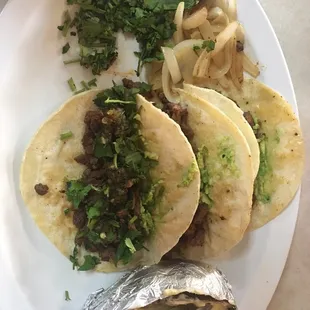 4 Steak Tacos with a baked potato, cilantro and onions. Also received a cup of fideo soup (yummmm) with my plate.