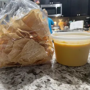 Large queso and look at the little bag of chips. Pretty greedy if u ask me.