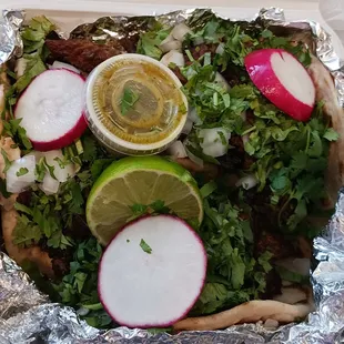 Three tacos with beef.