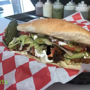 Tortas with your choice of meats, lettuce, tomatoes, pico de Gallo, sour cream and guacamole salsa.