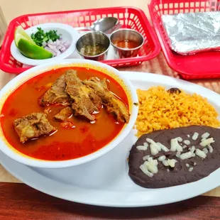 Birria De Chivo with black beans, rice and hand made tortillas.