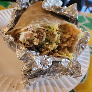 a burrito on a paper plate