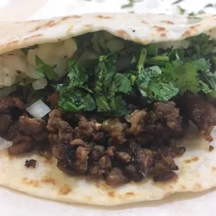 Carne Asada taco with onion &amp; cilantro.