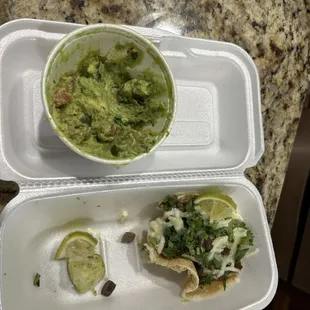 Steak tacos with side of guacamole and a steak burrito dinner.