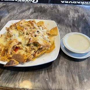 Shredded chicken nachos and cheese dip.
