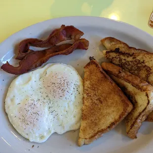 French toast and eggs over easy and bacon
