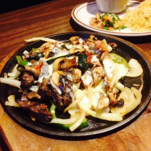 Fajitas Gratinadas. Fajitas topped with melted jack cheese. Roasted poblanos. Bacon &amp; mushrooms