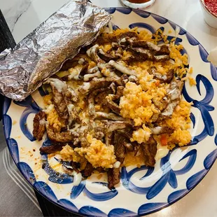 P10 Beef over rice smothered with queso