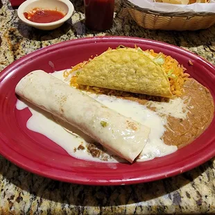 Combo 25 - Beef Burito, Beef Taco, Rice and Beans all covered in queso.