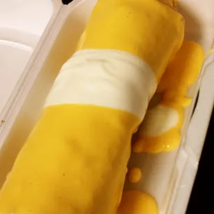 a cheese roll in a styrofoam container