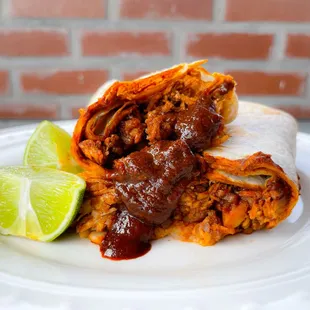 a burrito with a lime wedge