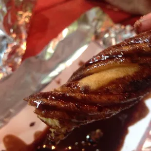 a hand holding a piece of food