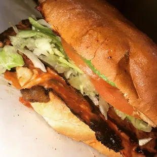 Grilled ham and cheese with red chili torta, lettuce, avocado and tomato.