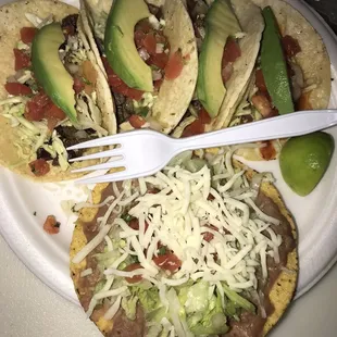 Carne asada tacos with avocado and a carne asada tostada.
