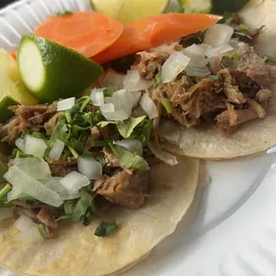 two tacos on a paper plate