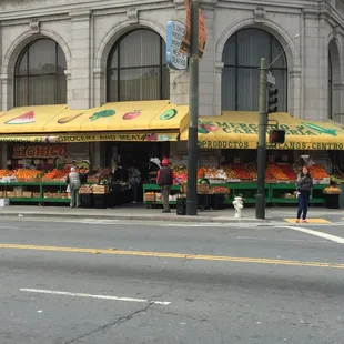 a fruit stand on a street corner