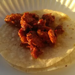 a taco on a paper plate