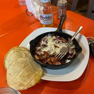 a skillet of food on a table