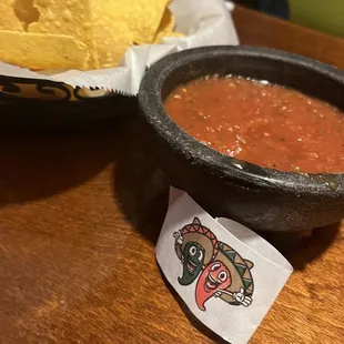 a bowl of salsa and a bowl of tortillas