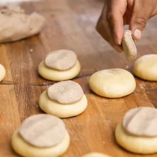 a person placing a cookie on a table