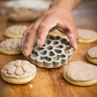 a person making cookies on a table