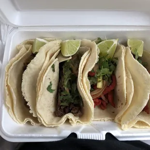 three tacos in a styrofoam container