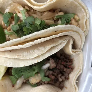 three tacos in a styrofoam container