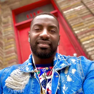 a man wearing a denim jacket and tie