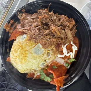Red chilaquiles with birria