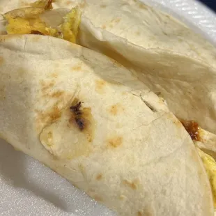 Generous serving of breakfast taco, a lot of filling that's definitely filling in the tummy too!