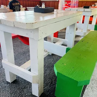Clean dining area located under cover in a parking lot.