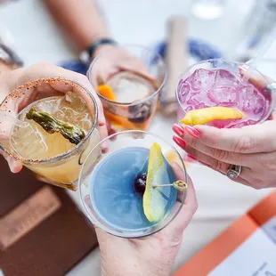 a group of people toasting with drinks