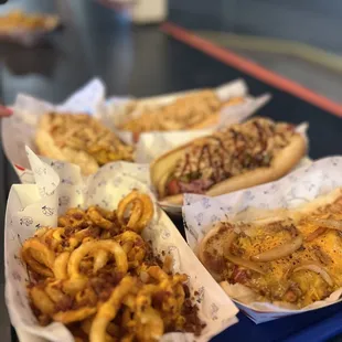 three hot dogs and french fries