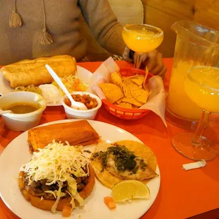 a plate of food and a glass of orange juice