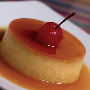 a flan flan with a cherry on top