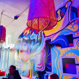 people sitting at tables in a brightly lit restaurant