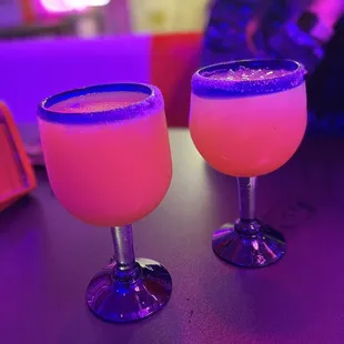 Frozen and on-the-rocks raspberry margaritas with a sugar rim.