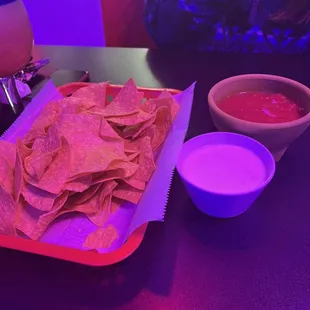 Chips with queso and salsa. The queso is delicious and the salsa is thick and the perfect amount of spicy.