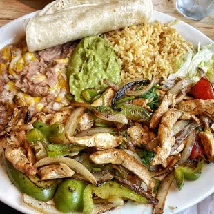 chicken fajitas with refried beans, Mexican rice, guacamole (which we ordered separately), and tortillas