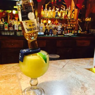 a bottle of tequila being poured into a glass