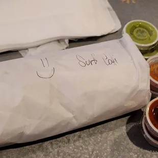 a burrito, salsa, and condiments
