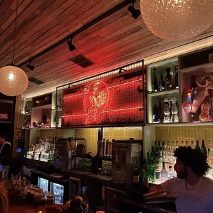 a bar with people sitting at the bar