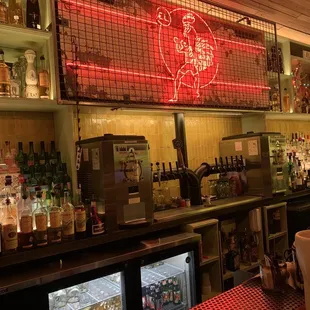 a bar with a neon sign above the bar