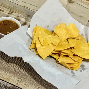 a basket of tortillas and a bowl of salsa