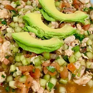 a bowl of soup with avocado