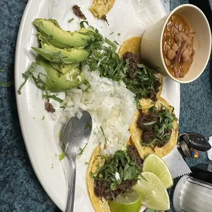 Mini barbacoa tacos that comes with frijoles and guacamole