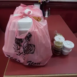 a pink plastic bag with a picture of a woman on it