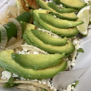 Bistec mini tacos w queso fresco and avocado